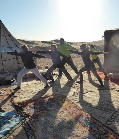 Die Yoga-Gruppe in der Morgendämmerung der Wüste